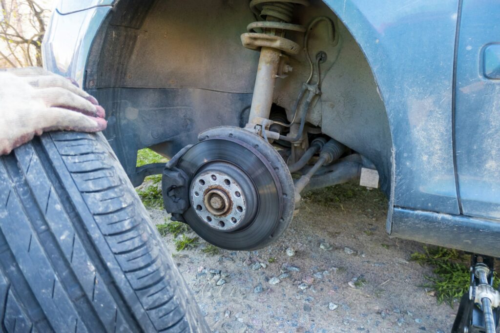 Change a flat car tire on road with Tire maintenance, damaged car tyre